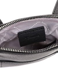 Borsa in pelle nera con chiusura zip, foderata in grigio con un motivo a pois e un piccolo etichetta nera all'interno.