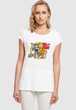 White cotton t-shirt featuring a colorful cartoon print of Tom and Jerry on the front. Short sleeves, relaxed fit, and round neckline.