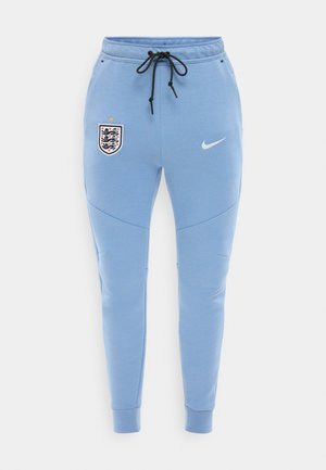 Šviesiai mėlynos Nike sportinės kelnės su juodomis raištelėmis, Anglijos futbolo komandos herbas kairėje šlaunyje ir baltas Nike logotipas dešinėje šlaunyje.