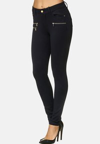 Marina smala jeans i stretchtyg, med guldfärgade dragkedjor på framfickorna och en figursydd design.