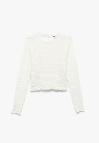 Hvid langærmet cropped top lavet af tekstureret stof med et bølget mønster og scalloped kanter ved halsudskæringen og kanten, med en snøre bagpå.