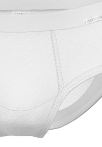 White cotton underwear with a soft texture, featuring a smooth waistband and contrast stitching details. Regular fit with a classic brief shape.