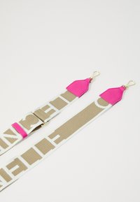 Adjustable fabric strap featuring a beige and white pattern, with pink leather accents and gold hardware clasps on each end.