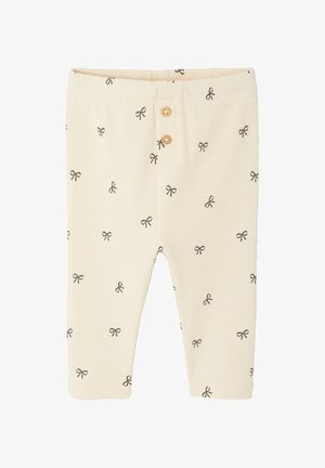 Babyschlaghose in Cremefarben mit feinen Rippen, kleinen schwarzen Schleifenmustern und zwei Holzknöpfen auf dem vorderen Taillenbund.