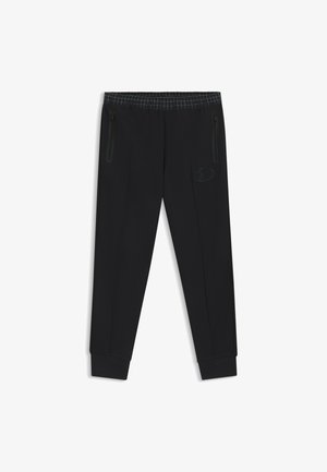 Pantaloni atletici neri con design affusolato, vita elastica con motivo a griglia, tasche laterali con zip e un piccolo logo sulla coscia.