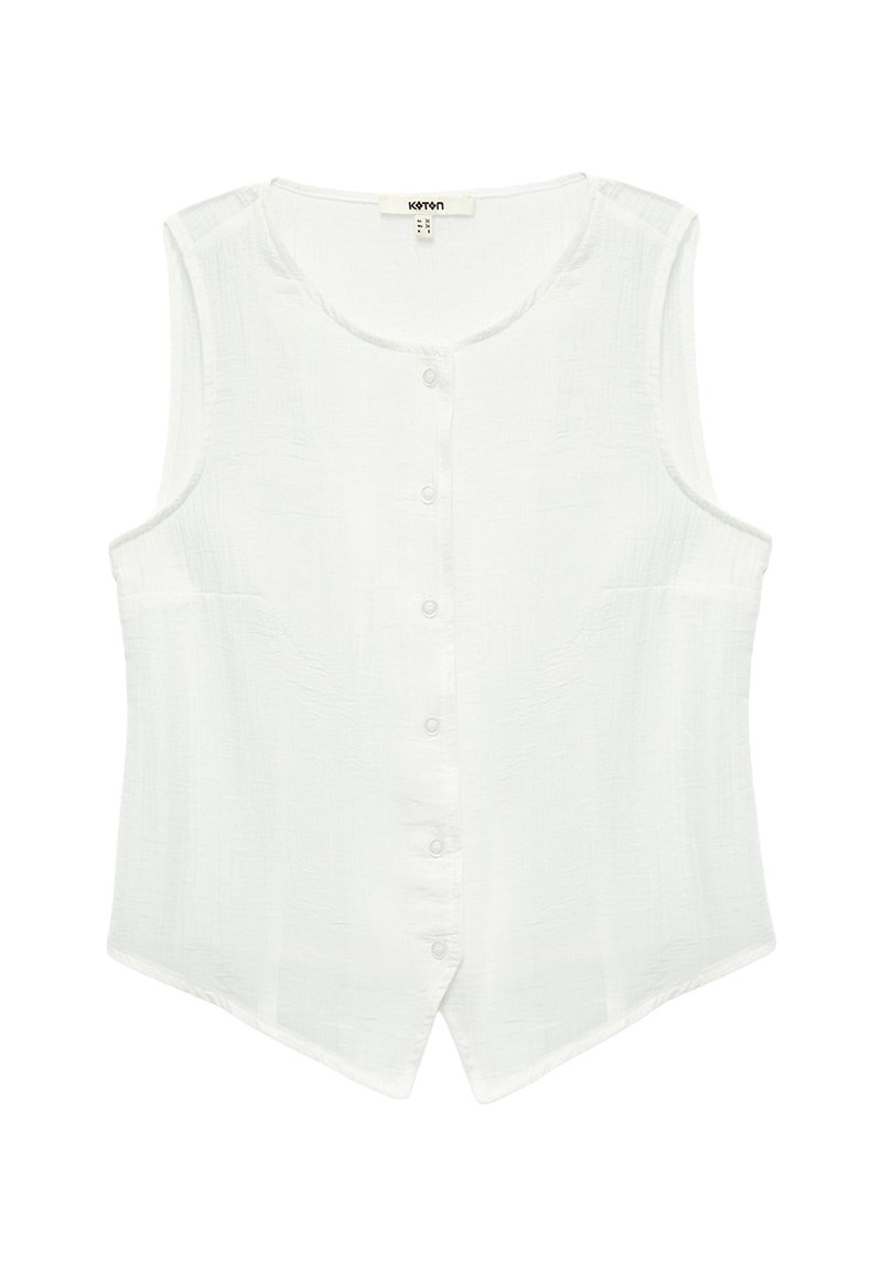 Blusa bianca senza maniche realizzata in tessuto testurizzato, con scollatura rotonda, chiusura con bottoni frontalmente e orlo leggermente curvato.