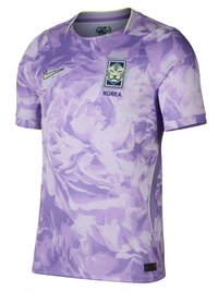 Laventelin ja valkoisen kukkakuosinen, lyhythihainen urheilupaita, jossa on leijonakuvio ja "KOREA"-teksti rinnassa sekä Nike-logo oikealla puolella.