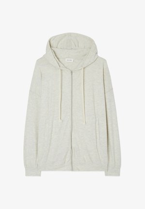 Sudadera con cremallera en gris claro, fabricada en un tejido suave y texturizado, con capucha ajustable y bolsillos frontales. Presenta mangas de corte holgado y un diseño relajado.