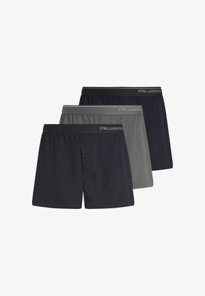 Tri muška bokserica Karl Lagerfeld u crnoj, sivoj i tamno plavoj boji, složene jednu na drugu s brendiranim elastičnim pojasom.