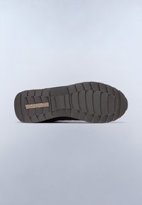 Black athletic shoe sole featuring a textured rubber surface with a patterned tread and embossed brand logo. Flat, durable construction visible.