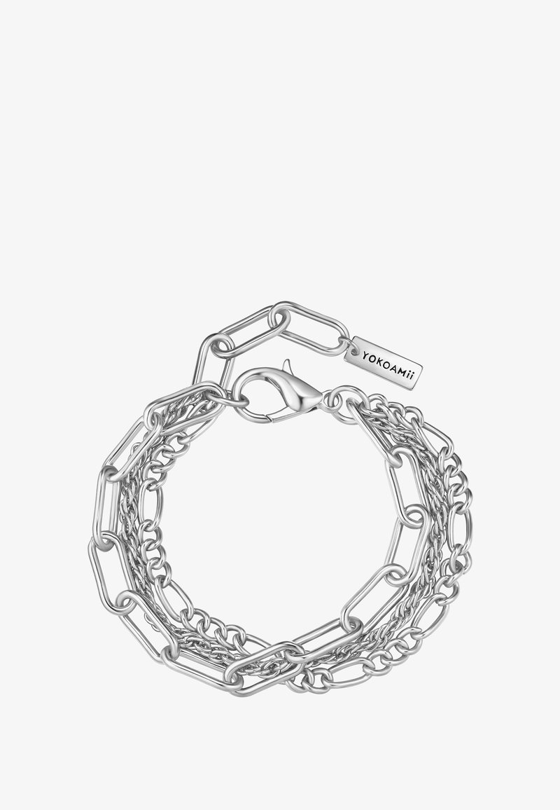 Hõbedane kettkäevõru, mis koosneb omavahel seotud ringikujulistest ja piklikest linkidest, kammiga lukuga ja sildi otsaga, millele on graveeritud "YOKOAMII."