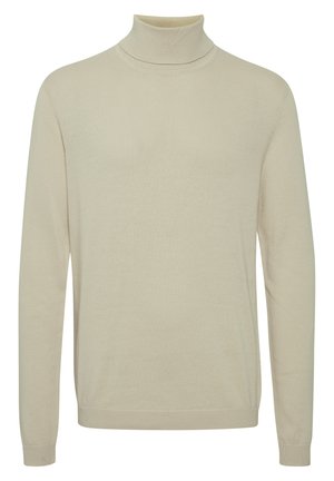 Suéter de cuello alto beige hecho de un material suave, con mangas largas, un cuello ajustado y una textura lisa con acentos acanalados en los puños.