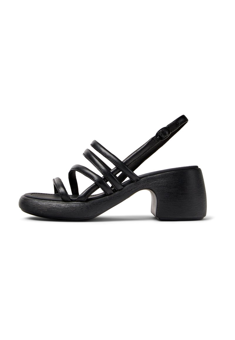 Black sandal with multiple thin straps, a rounded toe, and a chunky, textured heel. Adjustable ankle strap for secure fit.