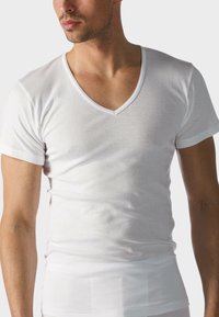 White cotton V-neck t-shirt with short sleeves, fitted design, smooth texture, and a simple, clean silhouette.