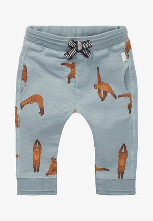 Niebieskie spodnie dziecięce z brązowymi ilustracjami leniwców w różnych pozach oraz czarno-białą paskowaną kokardką na pasie.