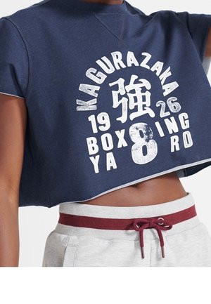 Navy cropped sweatshirt with white and maroon lettering, paired with light gray sweatpants featuring a maroon drawstring and waistband.