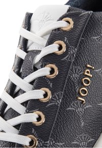 Lace-up sneaker featuring a textured dark grey synthetic upper with white accents, decorative gold eyelets, and embossed branding.