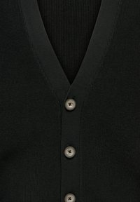 Cardigan nero a costine con scollo a V e tre bottoni grigi lungo la placca frontale, che mostra i dettagli della texture del tessuto.