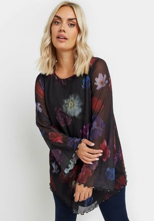 Durchsichtiger schwarzer Top mit einem floralen Muster in Rot, Lila und Weiß, mit ausgestellten Ärmeln und einer gewellten Saumpegelung.