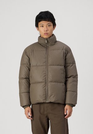 Brown puffer jacket with a high collar, featuring a front zipper and horizontal quilting. Smooth, slightly shiny fabric texture.