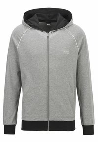 Felpa grigia con zip e dettagli neri, tessuto morbido, tasche frontali e una cappuccio interno a contrasto. Presenta profili bianchi lungo le cuciture.