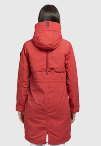 Red hooded jacket with a textured finish, featuring a zippered back vent and a mid-length cut. Includes an adjustable collar and sleeves.