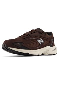 Brown mesh sneakers with dark brown accents, black rubber outsole, and reflective silver logo. Designed for comfort and stability.