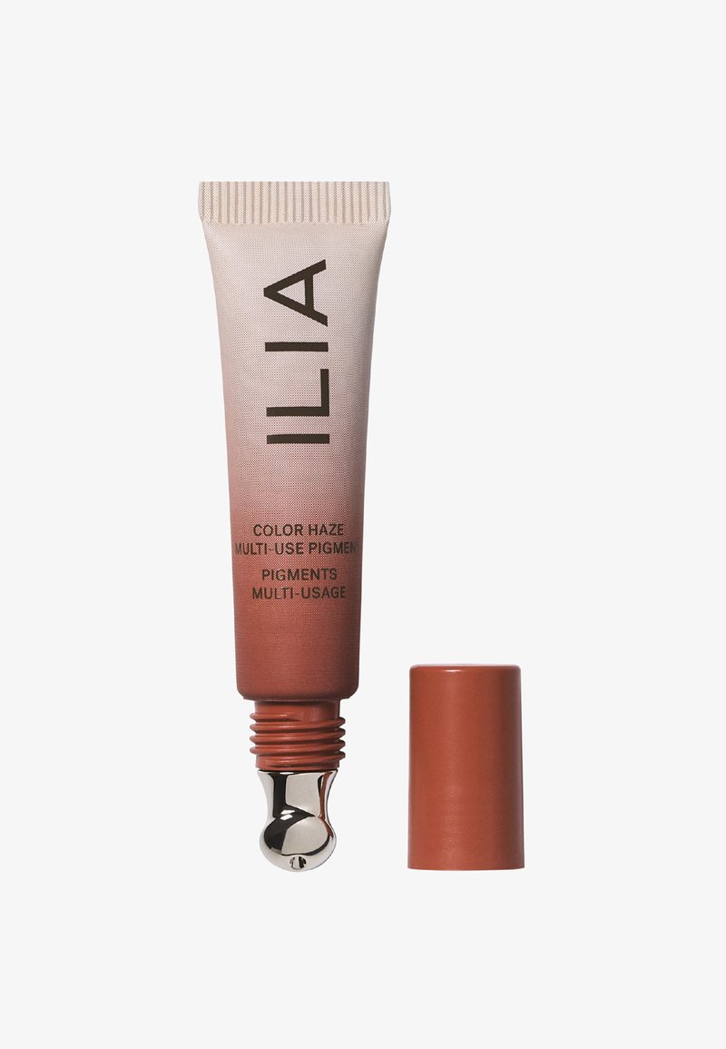 ILIA Color Haze Multi-Use Pigments in a soft peach plastic tube with a metallic rollerball applicator and a brown cap.