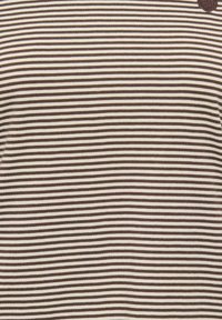 Brązowo-kremowa koszulka w paski o miękkiej fakturze. Wzór obejmuje poziome paski i małą emblemat na piersi.