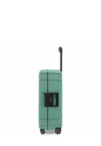 Valigia rigida verde menta con quattro ruote, manico telescopico nero estensibile e lucchetto TSA incorporato di lato.