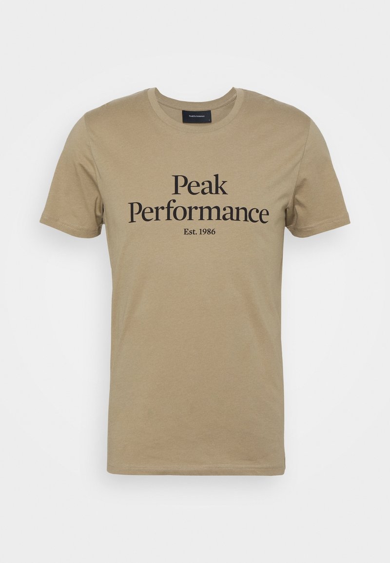 Beige bomuld t-shirt med korte ærmer og rund halsudskæring. Fronten er prydet med teksten "Peak Performance" og "Est. 1986" i sort.
