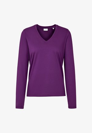Długi rękaw, bluzka z dekoltem w serek w jednolitym fioletowym kolorze. Wykonana z miękkiego, lekkiego materiału. Charakteryzuje się luźnym krojem i subtelnymi detalami szwów przy dekolcie.