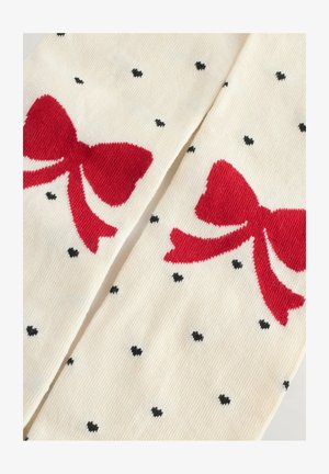 Kreemi värvi põlvini sokid punaste lipsukujuliste mustritega, tekstuuriga ribad ja juhuslikud väikesed mustad südamed, pakkudes mängulist mustrit ja pehmet viimistlust.