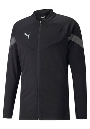 Veste de sport noire à manches longues, avec fermeture éclair et col montant. Présente un motif texturé sur les épaules et un logo argenté.