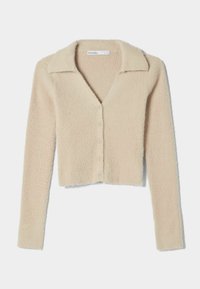 Beige kort cardigan tillverkad av mjukt, texturerat tyg, med knäppning framtill, v-ringning och långa ärmar med klassisk krage.