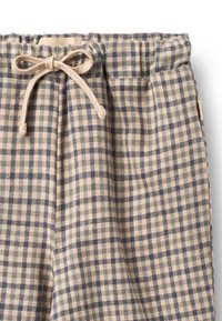 Beżowo-granatowe spodnie w kratę z elastycznym pasem i sznurkiem do regulacji. Charakteryzują się miękką fakturą materiału i widocznymi bocznymi kieszeniami.