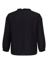 Svart bluse med lange ermer, volangkrage og blonder på skuldrene, elastiske mansjetter og løs passform, vist bakfra.