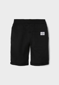 Black cotton shorts featuring a stretchy waistband, cuffed hems, and a back pocket with a brand label. Simple design with no patterns.