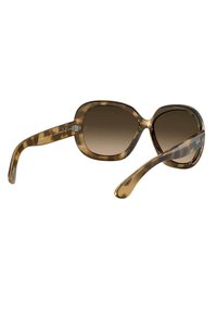 Occhiali da sole over-size tartarugati con lenti marroni sfumate, montatura in plastica liscia e aste snelle con dettagli metallici.