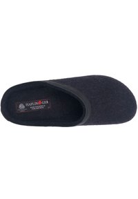 Black wool slipper with a closed toe and soft, textured surface. Features a smooth black trim along the opening and a label inside.