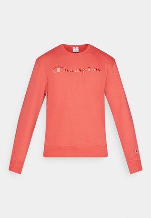 Koraalrode sweatshirt met lange mouwen, geborduurd "Champion" logo, geribde manchetten en tailleband. Zachte katoenen stof, klassiek ontwerp met ronde hals.