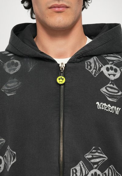 Felpa nera con cappuccio caratterizzata da una chiusura lampo anteriore, una linguetta a forma di smiley neon e varie stampe grafiche grigie. Materiale: tessuto morbido e casual.