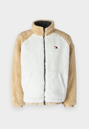 Fleecejakke i hvit og beige, med glidelås foran, høy krage, to lommer og ribbestrikkede mansjetter. Liten logo på venstre side.