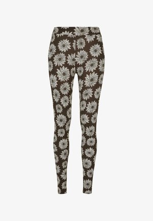 Leggings marron avec un motif floral blanc. Texture lisse, taille élastique, design ajusté, idéal pour une tenue décontractée.