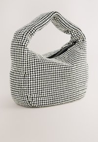 Black and silver embellished handbag with a rounded shape, a zip closure, and a chunky handle, featuring a grid of rhinestones on the surface.