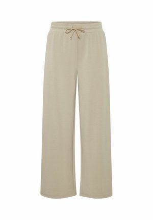 Beigeweite Hose aus weichem Stoff, mit einem elastischen Bund und Kordelzug. Keine Taschen; glatte Textur und einfaches Design.