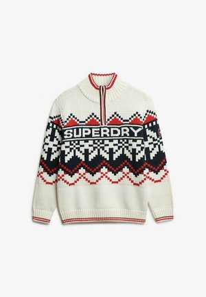Suéter de punto crema con cuello alto, que presenta un patrón geométrico en negro y rojo. En la parte delantera muestra "SUPERDRY" en letras gruesas.