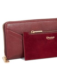 Burgundy leather wallet with a smooth texture, gold zipper, and accent. Includes a detachable cardholder in matching suede.
