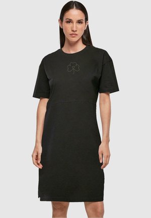 Schwarzes Kurzarmkleid aus Baumwolle mit einem dezenten Kleeblatt-Design in der Mitte. Lässige Passform und knielange Silhouette.