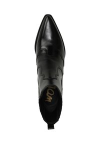 Stivale alla caviglia in pelle nera con punta appuntita, caratterizzato da un design scallop e pannelli laterali elastici per una facile indossabilità. Tacco piatto e linguetta di serraggio.